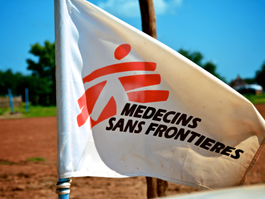 A white flag bearing MSF's logo