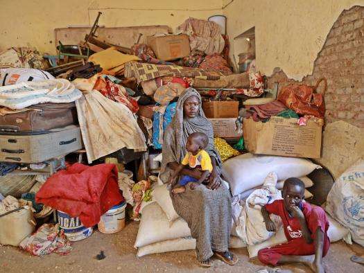 Displaced Sudanese woman with her children in Wad Madani, Sudan.