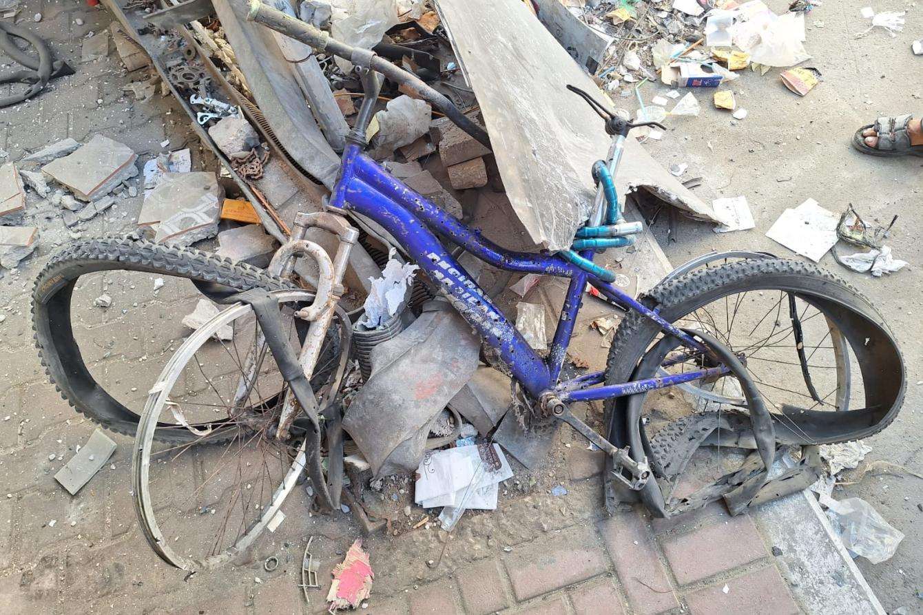 The crushed bike of MSF physiotherapist Fadi Al Al-Wadiya lies on the ground following an attack.